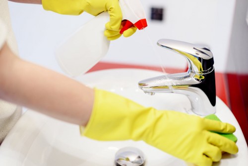 Cleaner treating stains on a living room sofa in Belgravia